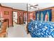 Large bedroom with a four-poster bed, blue floral bedding, and ample natural light at 201 Village Dr, Knightdale, NC 27545