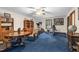 Bright bonus room with workout equipment, wood furniture, and a comfortable seating area at 201 Village Dr, Knightdale, NC 27545