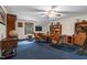 Bonus room with blue carpet, wood furniture, a ceiling fan, and a cozy atmosphere at 201 Village Dr, Knightdale, NC 27545
