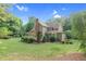 Expansive home exterior with manicured lawn and professionally landscaped greenery at 201 Village Dr, Knightdale, NC 27545