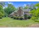Expansive home exterior with manicured lawn, brick chimney and professionally landscaped greenery at 201 Village Dr, Knightdale, NC 27545