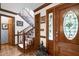 Elegant foyer with hardwood floors, a staircase, and a front door with a stained glass window at 201 Village Dr, Knightdale, NC 27545