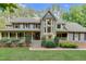 Charming two-story home with a bay window, landscaped yard, and covered porch with a stone walkway to the front door at 201 Village Dr, Knightdale, NC 27545