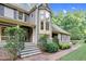 Inviting two-story home featuring stone steps, a bay window, and lovely, mature landscaping at 201 Village Dr, Knightdale, NC 27545