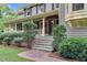Welcoming front porch with stone steps, walkway, and beautifully manicured shrubbery at 201 Village Dr, Knightdale, NC 27545