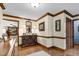 Entry hall with detailed trim and baseboards that leads to a glimpse of living room with fireplace at 201 Village Dr, Knightdale, NC 27545