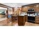 Charming kitchen with wood cabinetry, stainless steel microwave, and breakfast nook at 201 Village Dr, Knightdale, NC 27545