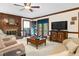 Living room featuring a brick fireplace, wood accents, and access to the outdoor area at 201 Village Dr, Knightdale, NC 27545