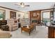 Traditional living room with wood accents, fireplace, ceiling fan, and plush seating at 201 Village Dr, Knightdale, NC 27545