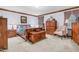 Comfortable main bedroom with wood furniture, soft carpet, and ample natural light at 201 Village Dr, Knightdale, NC 27545