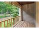 Covered porch with wooden railings and a view of the lush green yard at 201 Village Dr, Knightdale, NC 27545