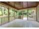 Screened porch with varnished wood ceiling and views of the backyard at 201 Village Dr, Knightdale, NC 27545