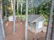 Charming shed with a porch, surrounded by trees, providing a serene backyard retreat at 201 Village Dr, Knightdale, NC 27545