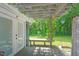 Back patio area with arbor featuring established vines overlooking green backyard at 202 Hilltop Ave, Garner, NC 27529