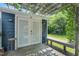 Back patio area with arbor featuring established vines overlooking green backyard at 202 Hilltop Ave, Garner, NC 27529