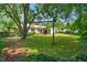 Large backyard features mature trees and a swing set, creating a serene outdoor space at 202 Hilltop Ave, Garner, NC 27529