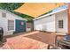 Private backyard featuring a brick patio covered by a large sun shade at 202 Hilltop Ave, Garner, NC 27529
