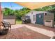 Fully fenced backyard featuring a brick patio with a shade sail at 202 Hilltop Ave, Garner, NC 27529