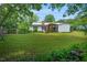 Lush green backyard with play area, mature trees and a fire pit provides a private outdoor retreat at 202 Hilltop Ave, Garner, NC 27529