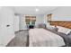 Comfortable bedroom with carpeted floors, neutral walls, and bamboo shades at 202 Hilltop Ave, Garner, NC 27529