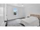 Bright bedroom featuring neutral carpet, natural light from a window, and simple furnishings at 202 Hilltop Ave, Garner, NC 27529