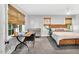 A bedroom featuring multiple windows with bamboo shades and neutral colored walls at 202 Hilltop Ave, Garner, NC 27529