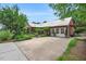 Spacious driveway complements a brick home with well-maintained landscaping at 202 Hilltop Ave, Garner, NC 27529