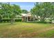 Traditional home with a metal roof, mature trees and manicured lawn at 202 Hilltop Ave, Garner, NC 27529
