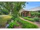 Charming brick pathway leads to a well-maintained home with lush greenery at 202 Hilltop Ave, Garner, NC 27529