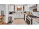 Bright kitchen features white cabinets, stainless steel appliances, and a view from the window at 202 Hilltop Ave, Garner, NC 27529