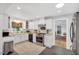 Lovely kitchen featuring stainless steel appliances, white cabinets, and a view from the window at 202 Hilltop Ave, Garner, NC 27529