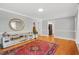 Hardwood floors, neutral walls, and a decorative rug in a bright living room at 202 Hilltop Ave, Garner, NC 27529