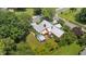 An aerial rear view of a brick home with unique, light colored roof and green lawn at 202 Hilltop Ave, Garner, NC 27529
