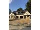 New construction featuring brick base, white siding, and a two-car garage at 203 S Main St # B, Four Oaks, NC 27524