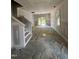Bright living room with stairs, neutral walls, and French doors to the backyard at 203 S Main St # B, Four Oaks, NC 27524