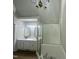 Bright bathroom featuring tub/shower combo and glass door at 2032 Sherry Lynn Dr, Garner, NC 27529