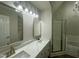Bathroom featuring dual vanity with quartz countertop, and glass enclosed shower at 2032 Sherry Lynn Dr, Garner, NC 27529
