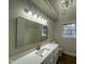 Bright bathroom featuring a quartz countertop, stylish vanity, and modern fixtures at 2032 Sherry Lynn Dr, Garner, NC 27529
