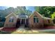 Charming brick home featuring arched windows and a cozy front porch at 2032 Sherry Lynn Dr, Garner, NC 27529