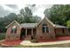 Charming brick home featuring arched windows and a cozy front porch at 2032 Sherry Lynn Dr, Garner, NC 27529