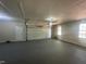 Spacious garage featuring epoxy floor, garage door opener, and natural light at 2032 Sherry Lynn Dr, Garner, NC 27529