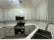 Well-equipped kitchen featuring a stainless steel range, microwave, and quartz countertops at 2032 Sherry Lynn Dr, Garner, NC 27529
