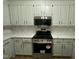 Well-lit kitchen features a stainless steel range, microwave, light-colored cabinets, and quartz countertops at 2032 Sherry Lynn Dr, Garner, NC 27529