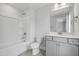 This well-lit bathroom features a combined shower and tub, toilet, sink, and vanity at 209 Broomgrove Way, Wake Forest, NC 27587