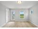 Light-filled bedroom with three windows, a door to the outside, and neutral carpet and paint at 209 Broomgrove Way, Wake Forest, NC 27587