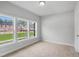 Sunlit bedroom with three windows, neutral carpet, and light gray walls, providing ample natural light at 209 Broomgrove Way, Wake Forest, NC 27587