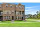 Exterior view of a new brick townhome with a manicured lawn at 209 Broomgrove Way, Wake Forest, NC 27587