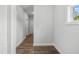 Bright hallway features wood-look flooring and white walls, leading to other rooms at 209 Broomgrove Way, Wake Forest, NC 27587