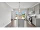 Modern kitchen with stainless steel appliances, neutral paint and island with sink at 209 Broomgrove Way, Wake Forest, NC 27587
