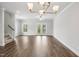 The living room features hardwood floors, white walls, a ceiling fan and a staircase to the left at 209 Broomgrove Way, Wake Forest, NC 27587